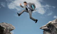 businessman jumping over skill gap