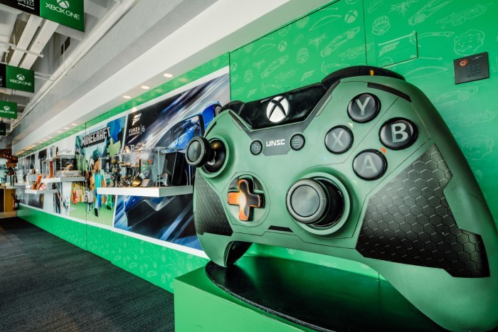 Xbox wall showcases the latest Xbox One, accessories, premium gifts, special edition cross-over designs with brands and exhibits of the Xbox-exclusive game Halo.