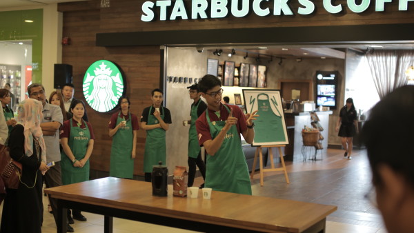 Deaf shift manager, Aizad conducting coffee tasting