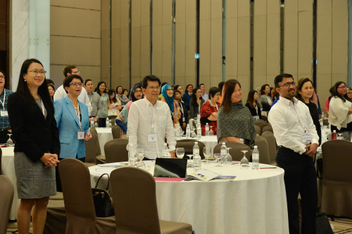 Delegates sing in unison at the start of Peter Ling's presentation.