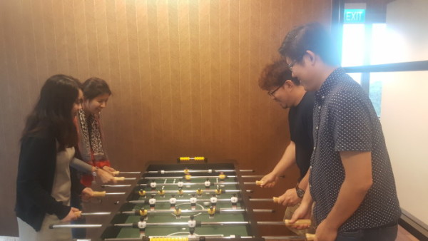 HomeAway employees playing foosball