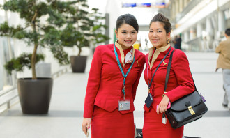 Cathay Pacific crew members posing in airport